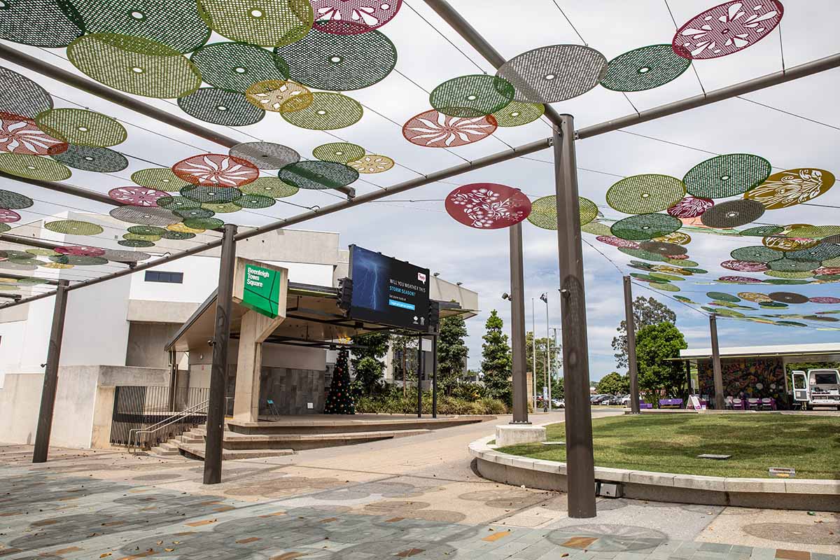 Decorative circles form undercover area in the outdoor space