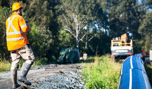 A Council worker working on a road installing water infrastructure