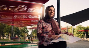 Council employee holding plans in a new park