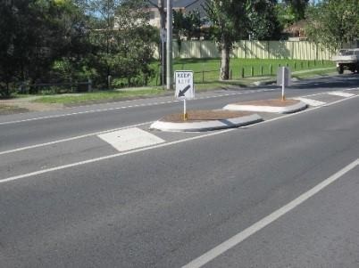 traffic island refuge in the middle of the road to help cross the road
