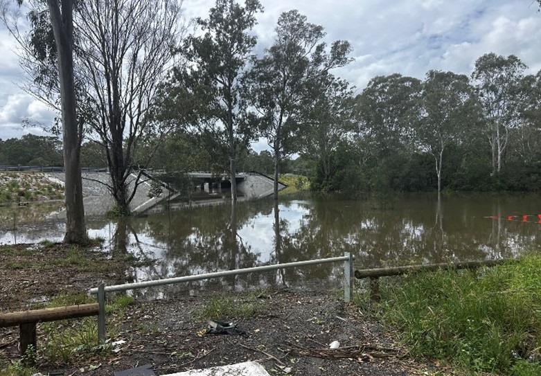 View of the former low level road crossing showing the flooding with the new bridge above the water level during cyclone alfred