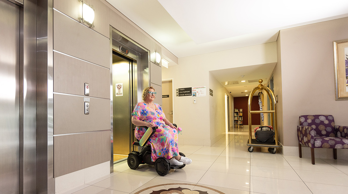 Woman in wheelchair coming out of lift at Hotel Gloria