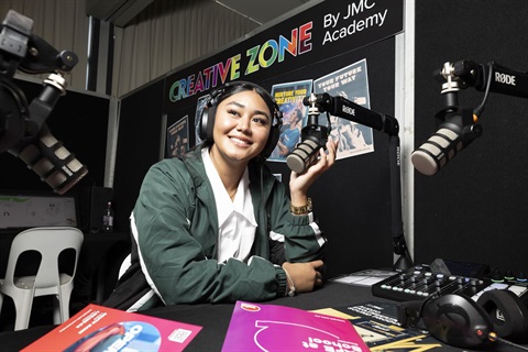 Youth trying audio equipment at expo
