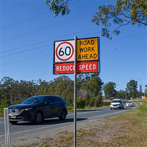 A roadwork ahead reduce speed and a 60 kilometre speed sign 