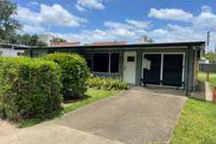 Frontage of business at Rochedale South after renovations - bricks have new paint, a new door has been installed and trim has been upgraded