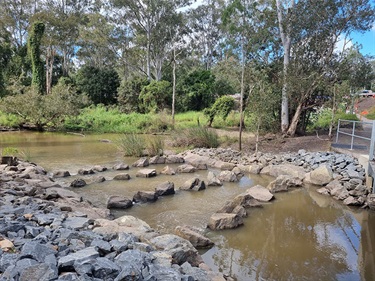 Fishway made up of rocks across a creek to encourage native fish movement