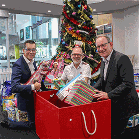 Salvation Army Captain Ashley Biermann (centre) collected a much-appreciated donation of toys and gifts from Logan City Council CEO Darren Scott (left) and Director Organisational Services Robert Strachan (right).