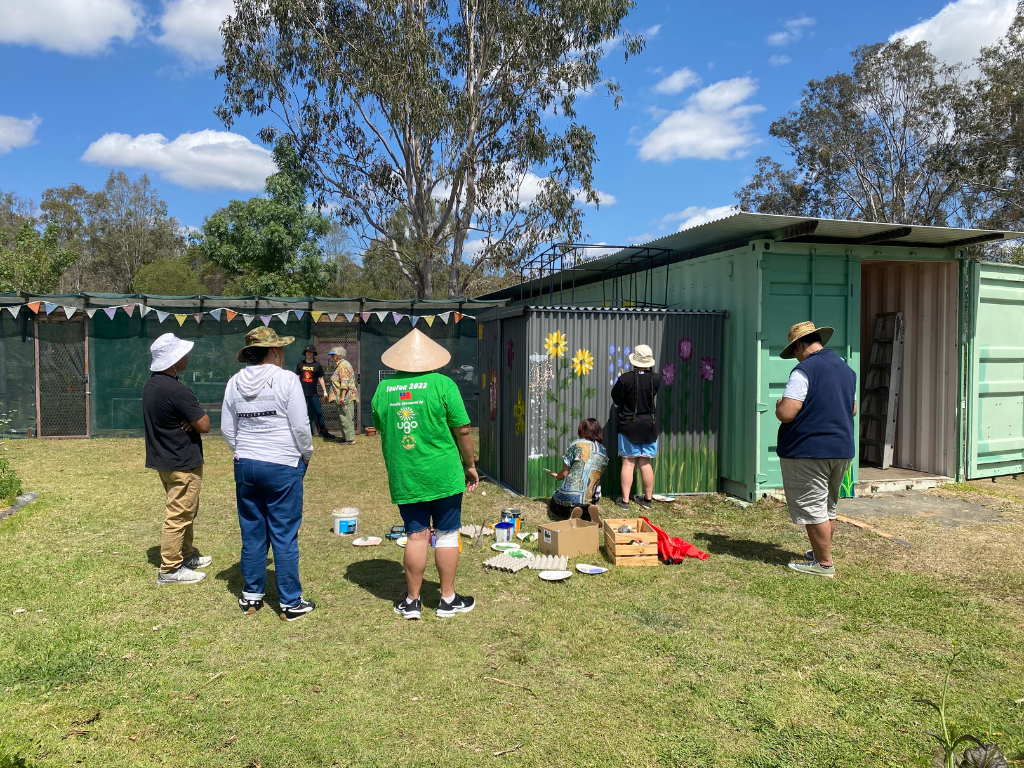 Volunteers painting a mural at Jimboomba Community Garden