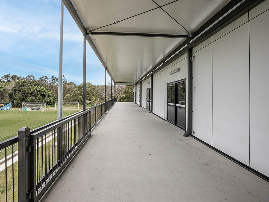 Fenced balcony overlooking sports field