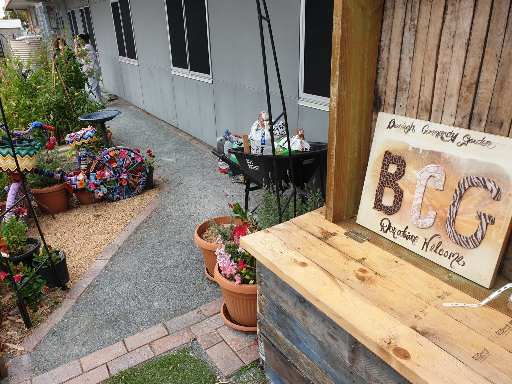 Workshop bench and sign that reads Beenleigh Community Garden