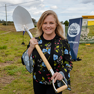 City Lifestyle Committee Chair and Division 4 Councillor Laurie Koranski, holding a shovel, at the sod turning for the new riverside pathway at Logan Village.
