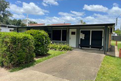 Frontage of business at Rochedale South after renovations - bricks have new paint, a new door has been installed and trim has been upgraded.