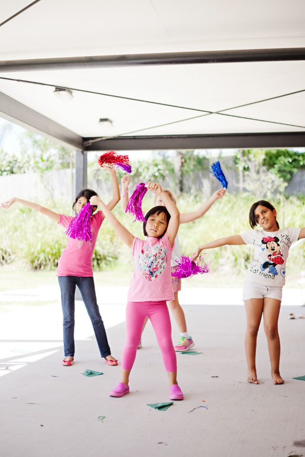 Children dance and wave ribbons above their heads