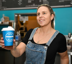 This is a photo of a woman holding a coffee cup