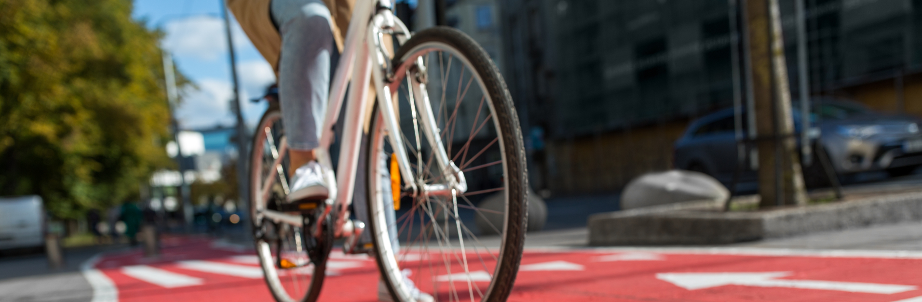 A person riding a white bike on a shard pathway