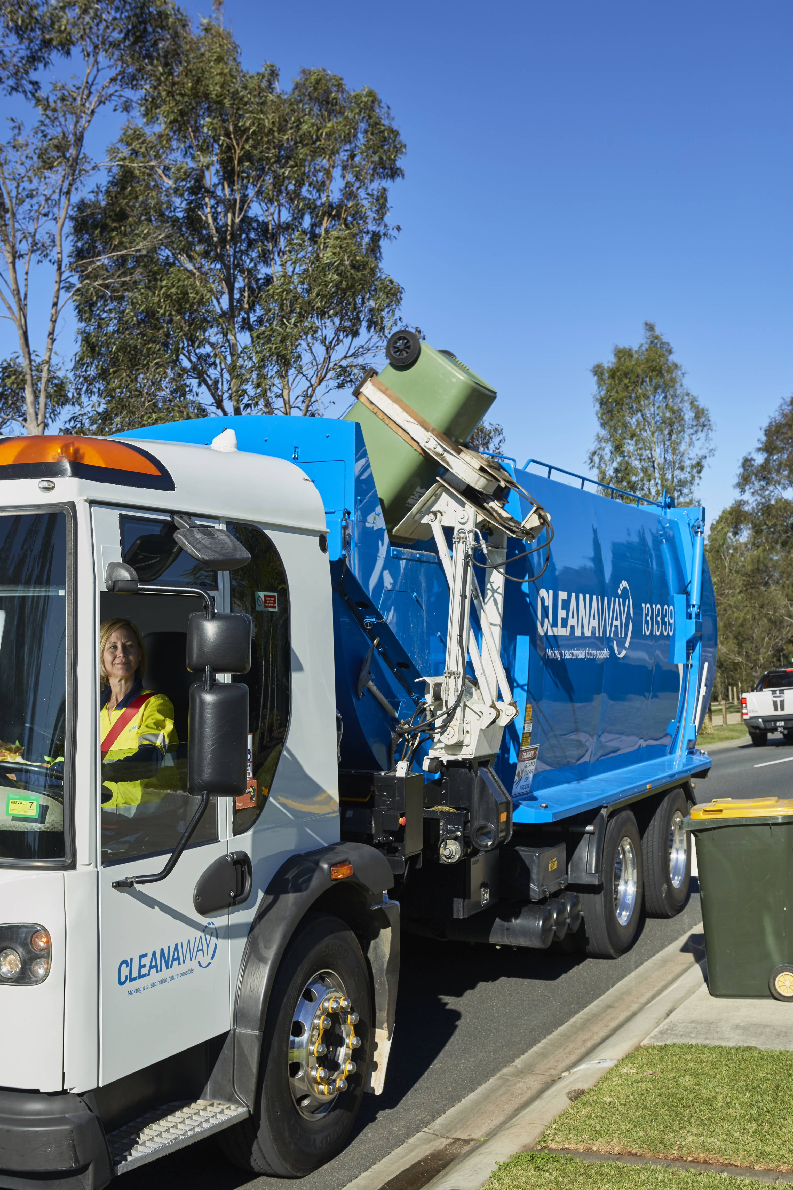 This is a picture of a garbage truck collecting a residential bin