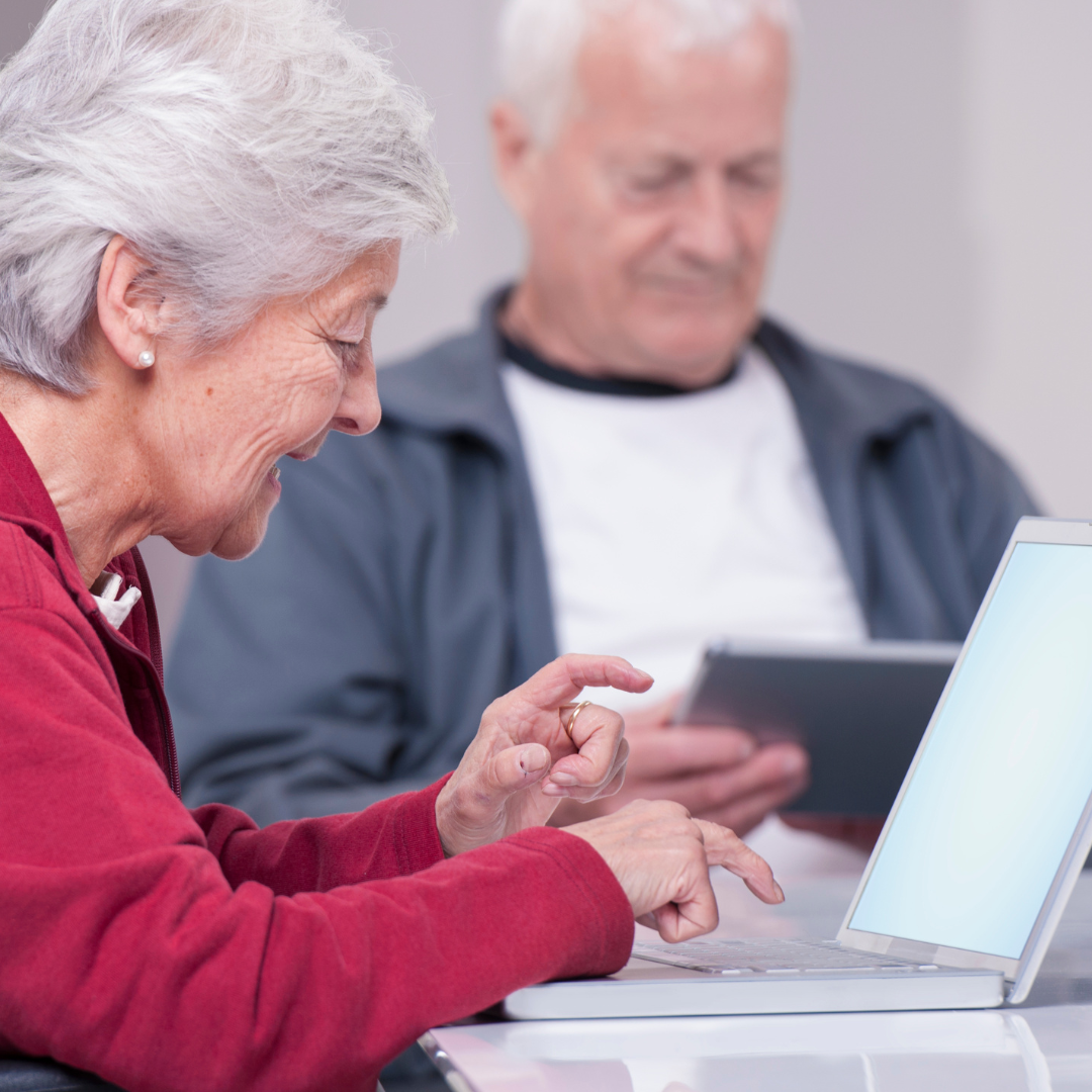 two seniors using computers