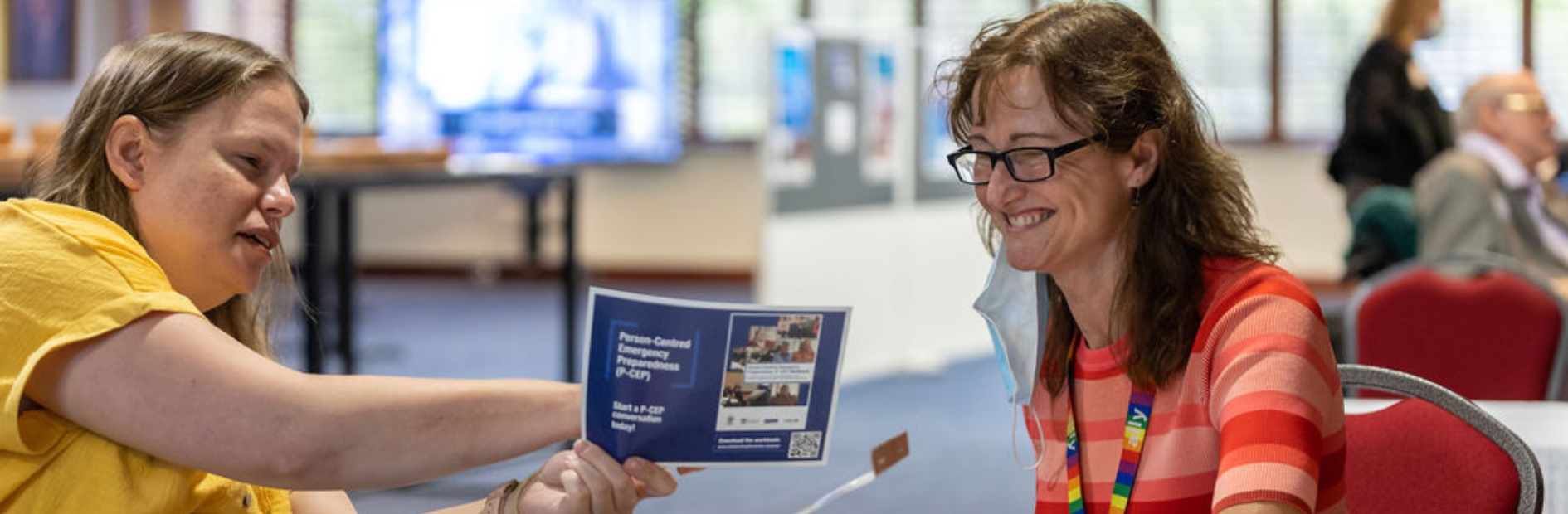 Two people looking at a pamphley
