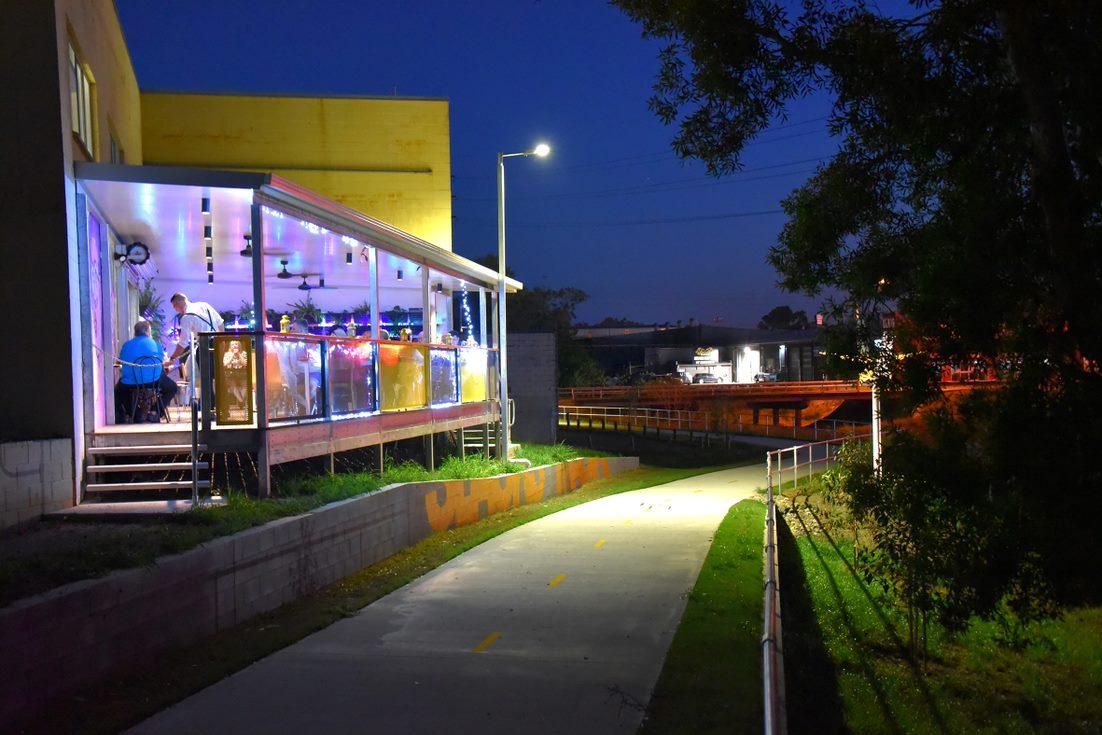 Picture of the deck extension at Extraction Artesian Coffee overlooking the walkway at night