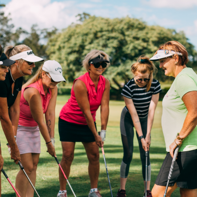 a group of women playing golf