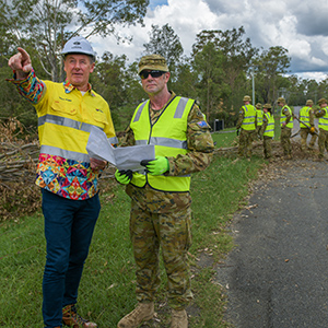 An image of Mayor Darren Power (left) and ADF Sergeant Jason Hatcher, whose Alpha Team were on storm clean-up in the Logan suburb of Cedar Grove today.
