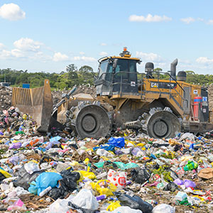 An image of a tractor burying waste to show that Operations will continue over Easter at the Browns Plains Waste and Recycling Facility.