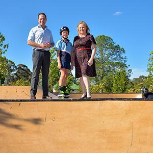 Councillors Jon Raven and Laurie Koranski with Kaylah-Bree Ilett at the new Logan VIllage Green Skate Park.