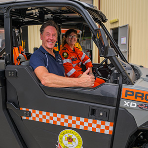 Man and SES volunteer sit in a new all terrain vehicle