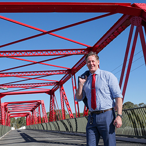 Mayor Darren Power, pictured on the iconic Red Bridge adjacent to the M1, says the City of Logan is well-placed to share its diverse experiences and cultural cuisines with the world.