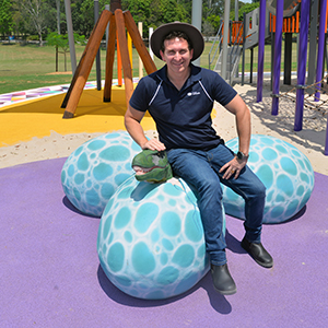 An image of Lifestyle Chair and Division 6 Councillor Tony Hall among the &#039;dinosaur eggs&quot; at the new playground in Riverdale Park at Meadowbrook.