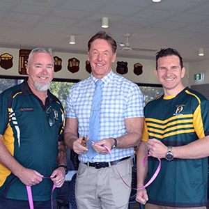Three men with scissors to cut ribbon to open clubhouse