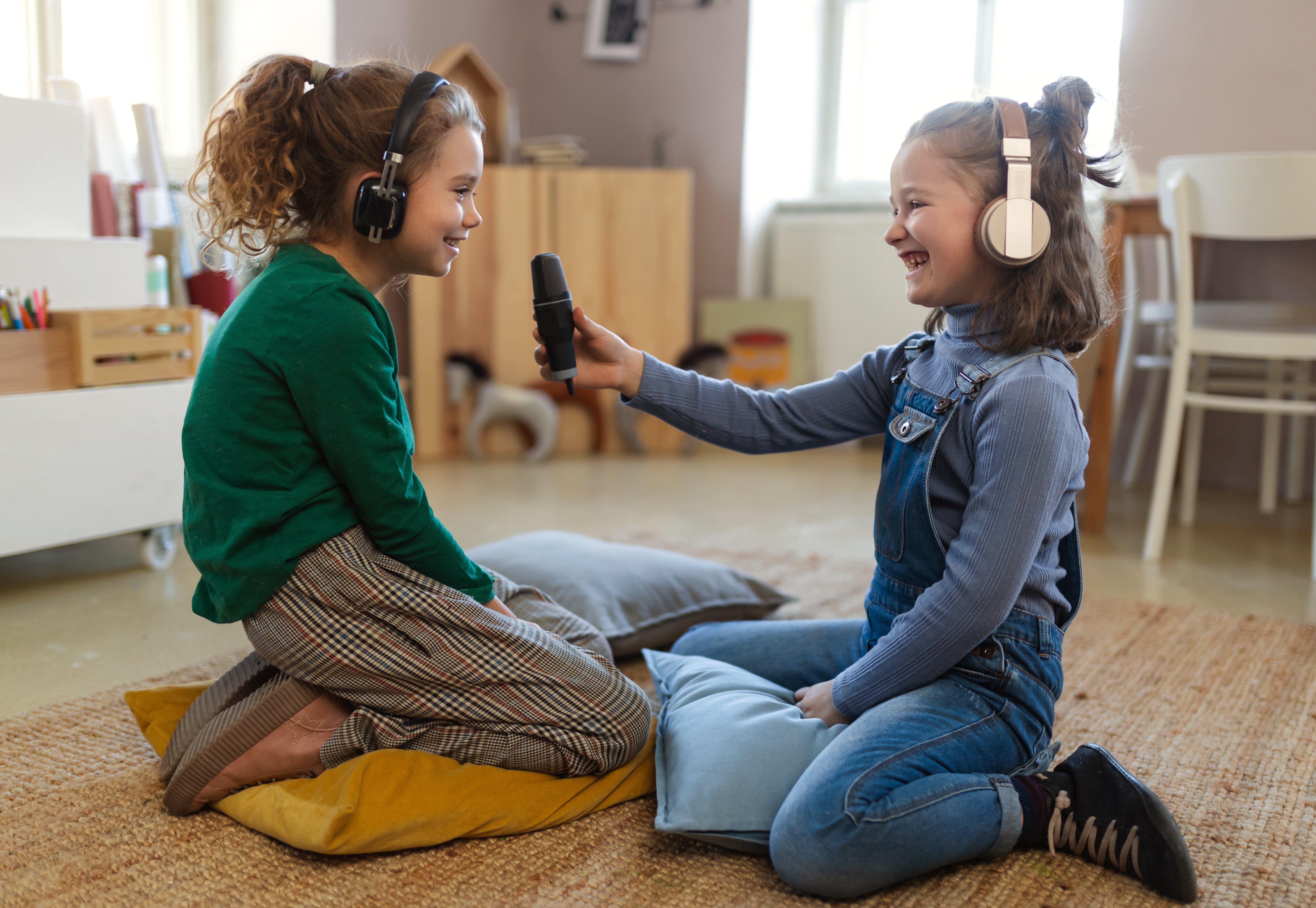 A child interviewing another child with a microphone