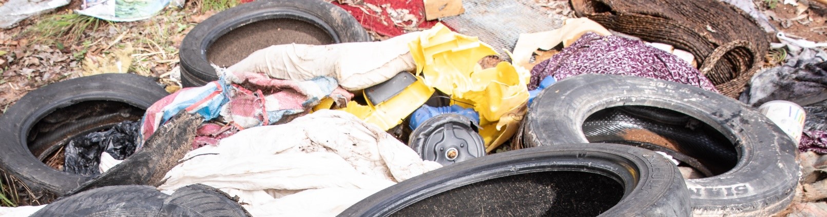 A collection of waste, including old tires and clothing