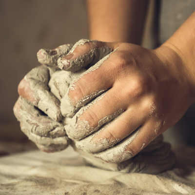Moulding a clay to make a cup and plate