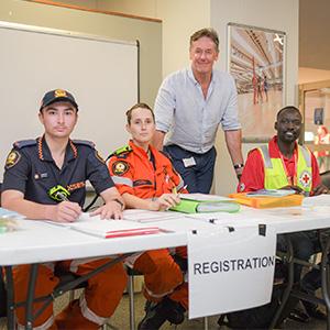 City of Logan Mayor Darren Power with SES and Red Cross staff in the Logan Metro Sports & Events Centre at Crestmead this afternoon.