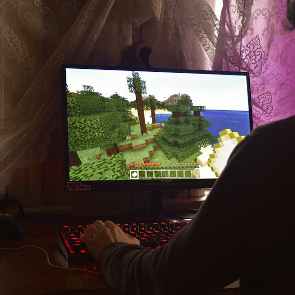 Child playing minecraft on a computer screen