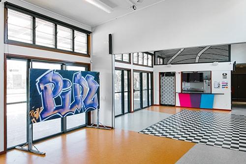 open space with checkerboard floor and blackboard with artistic graffiti