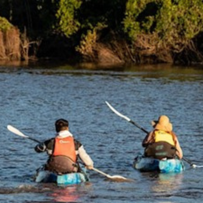 two people in canoes in the river