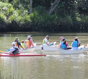 two people in canoes in the river