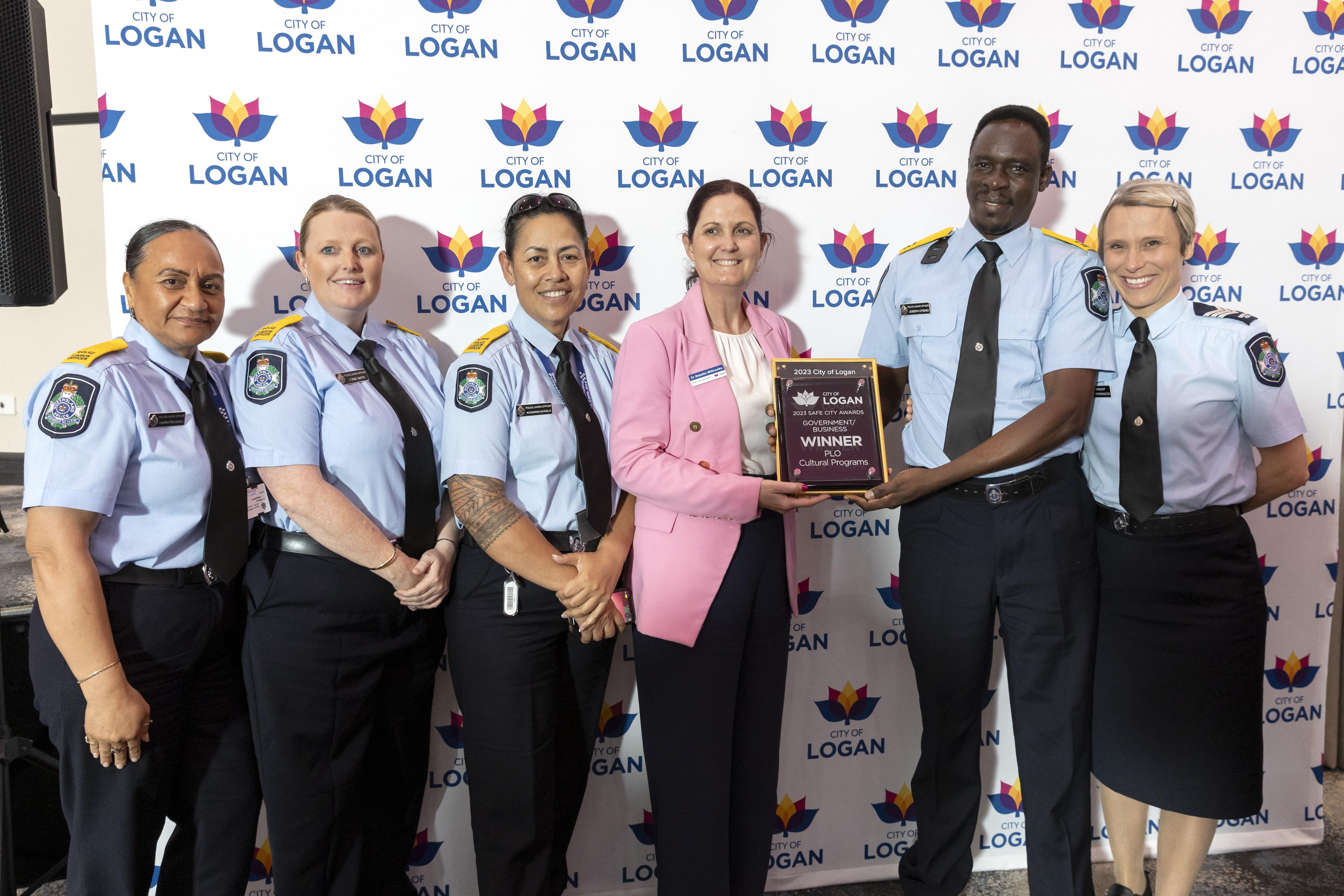 Government/Business category winner Maria Fakahau, Codie Smith, Serena Daniels, Joseph Otieno and Vernita Pennington from PLO Cultural Programs with Cr Natalie Willcocks at City of Logan Safe City Awards