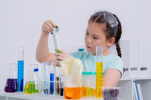 a girl filling up beacons with lots of different coloured fluids