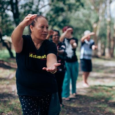 A group of people in the park doing Tai chi