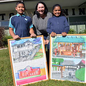 Division 2 Councillor Teresa Lane with Harris Fields State School students Shane S'ua (left) and Akazee Dorante.