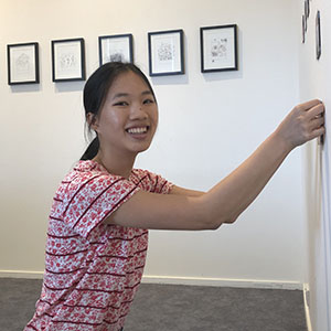 Hanging her work at the Logan Art Gallery is young artist Teresa Poon.