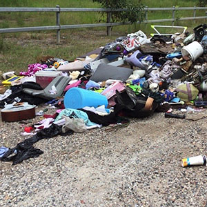 Rubbish is left on the side of a road