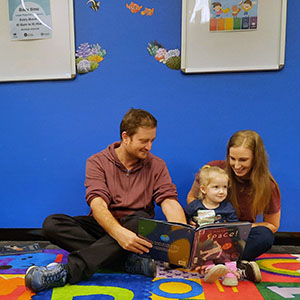 This is an image of a Logan family reading the featured story for National Simultaneous Storytime,