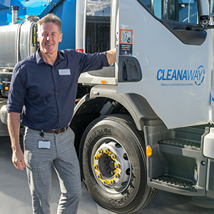 An image of City of Logan Mayor Darren Power standing in front of a truck at the new Cleanaway depot at Crestmead.