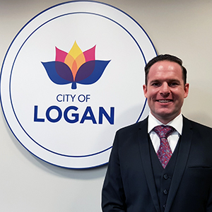 An image of Logan City Council Deputy Mayor Jon Raven in front of the city logo after his reappointment to the position.