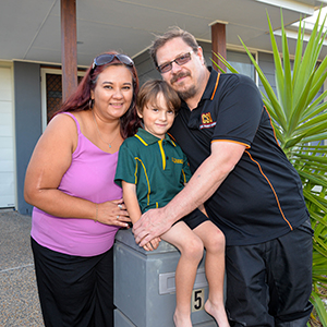 An image of Jason, Jasmine and Tyson van Sleeuwan outside their current home. The family is renting in Yarrabilba as they await construction of their new home in the booming Logan suburb.