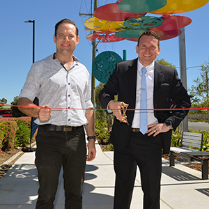 An image of Deputy Mayor Jon Raven and Councillor Tony Hall (Division 6) cutting a ribbon to open the Loganlea Road Healthy Street precinct.